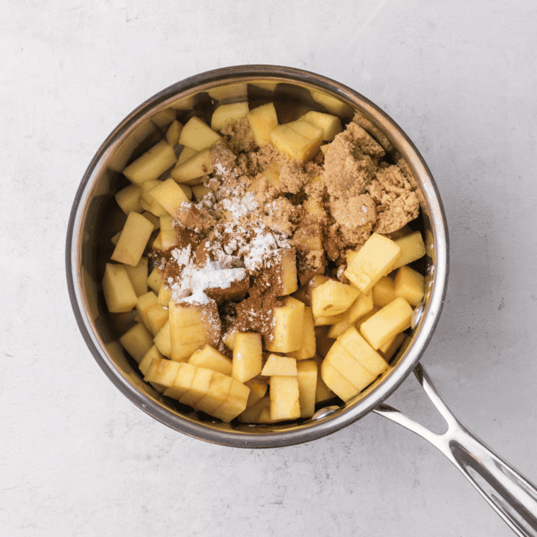 Peel and slice apples, toss with sugar, cinnamon, and lemon juice, then cook until tender and thickened.