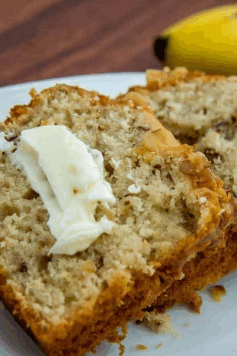 Sliced air fryer banana walnut pound cake with golden crust and walnuts.