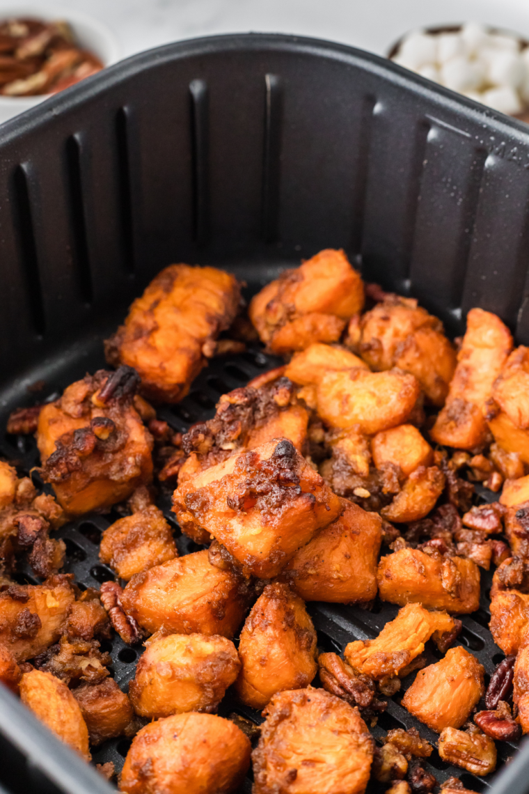 Place canned sweet potatoes in a single layer in the air fryer basket.