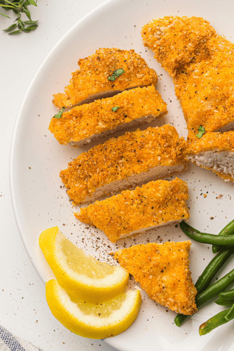 Crispy and golden breaded chicken cutlets in an air fryer basket