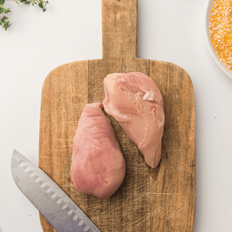 Preheat air fryer to 380°F and slice chicken breasts into cutlets.