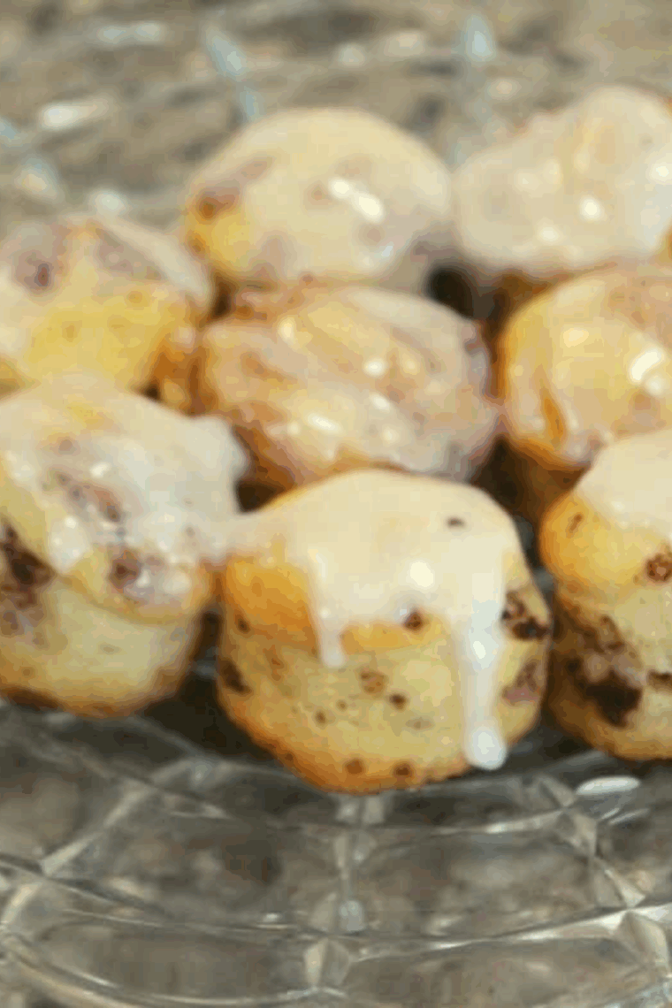 Golden, gooey cinnamon roll bites cooked in an air fryer, drizzled with glaze.