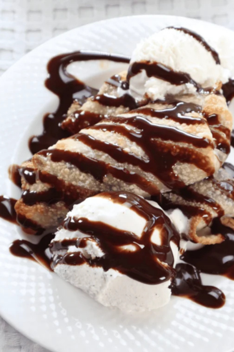 Crispy cookie dough egg rolls served warm with vanilla ice cream and hot fudge sauce