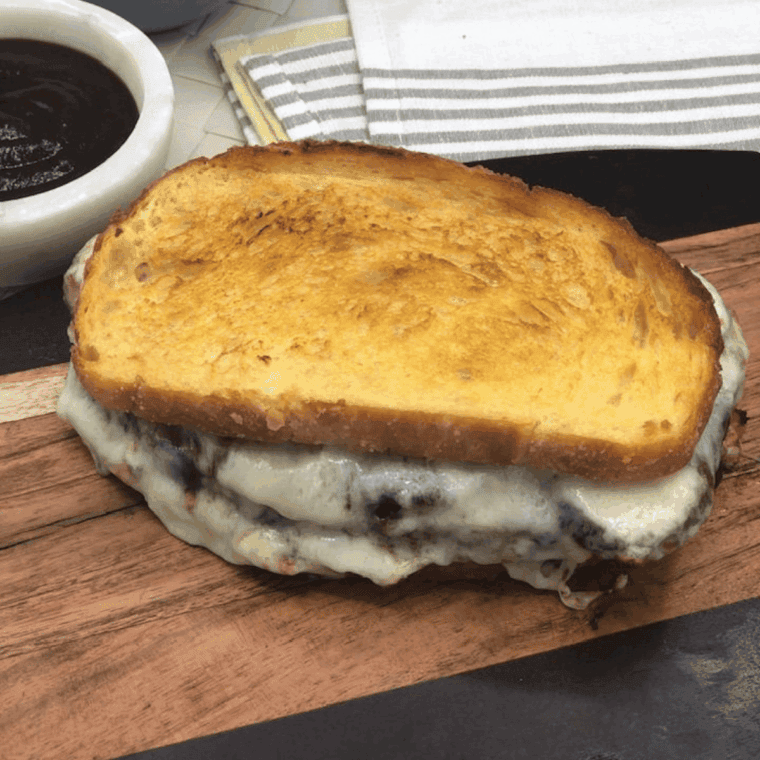 Golden, cheesy Air Fryer Italian Meatloaf topped with marinara and melted mozzarella in a loaf pan.