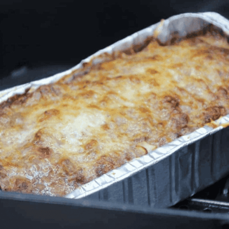 Sliced Italian meatloaf cooked in the air fryer, topped with marinara and melted mozzarella.