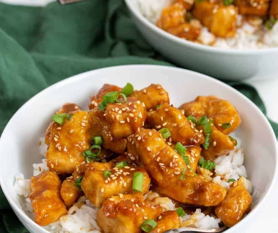 Air Fryer Sesame Chicken with homemade sauce topped with sesame seeds