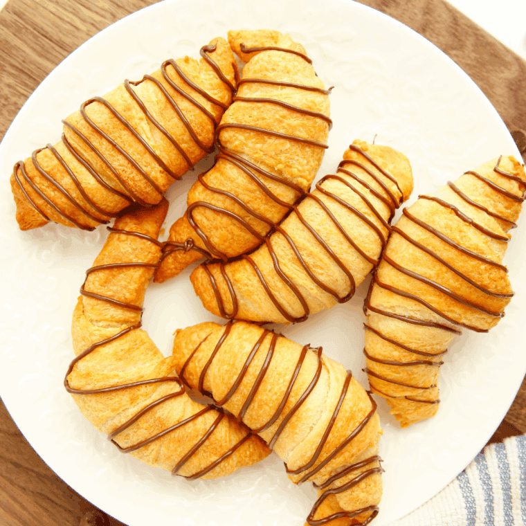Golden, flaky chocolate turnovers on a baking sheet, inspired by Arby’s signature dessert.