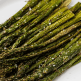 Crisp-tender Blackstone asparagus charred on the flat top with garlic, lemon, and Parmesan. This easy griddle side dish is ready in just 10 minutes with 5 simple ingredients.