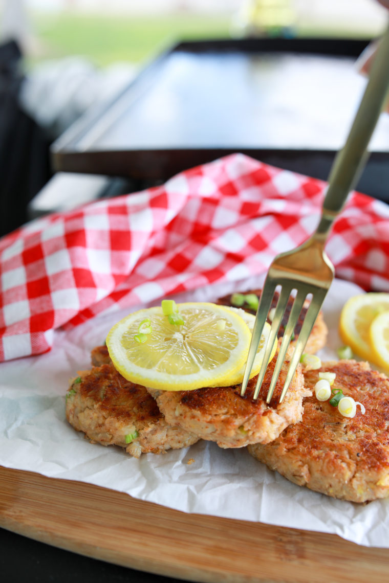 Golden brown crab cakes cooking on the Blackstone griddle, ready to be served.