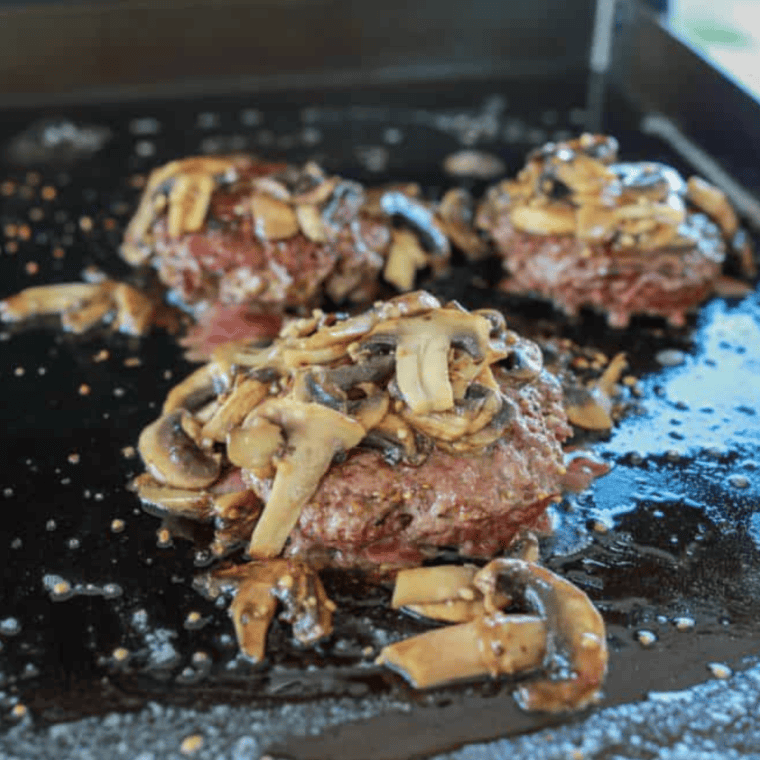 Top burgers with mushrooms and Swiss cheese, melt.