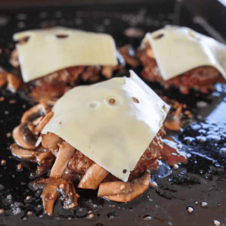 Add sautéed mushrooms and Swiss cheese to burgers, melt.