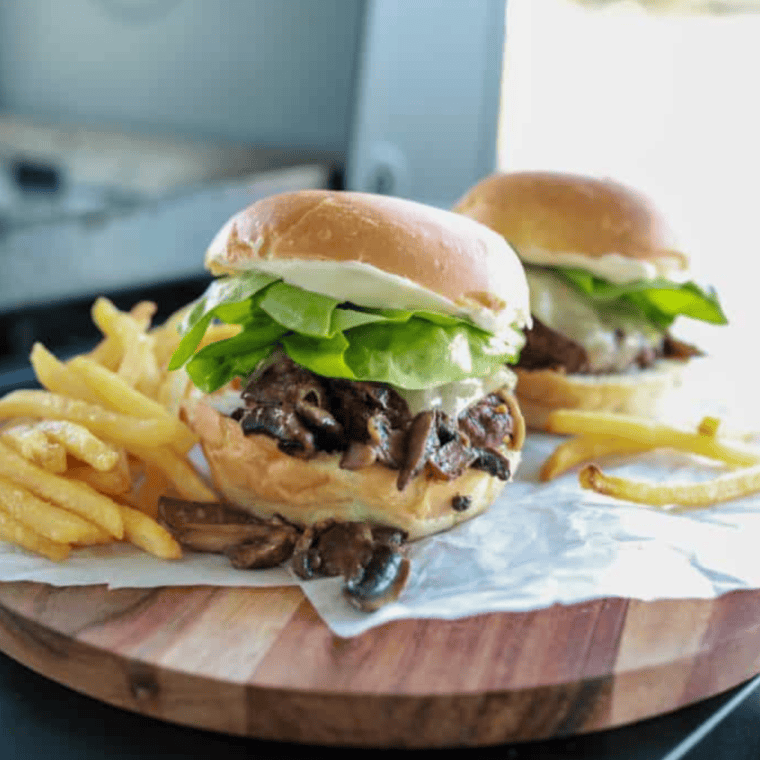 Blackstone Mushroom Swiss Smash Burger with sautéed mushrooms and Swiss cheese on a toasted bun.