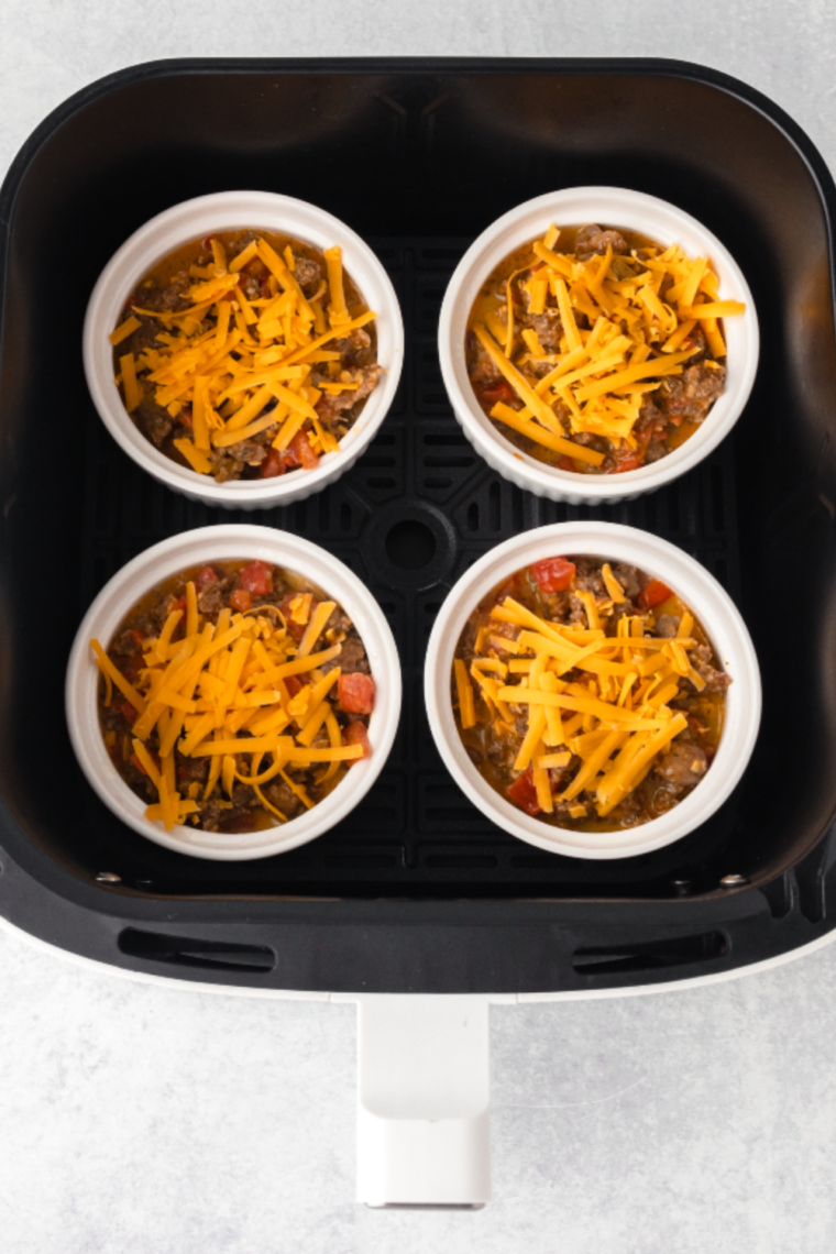 Closeup of 4 egg bakes in the air fryer basket