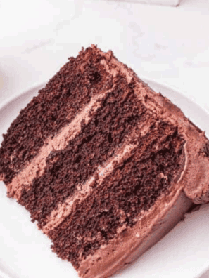Slice of Cheesecake Factory Linda’s Fudge Cake with thick fudgy frosting and moist chocolate cake layers.