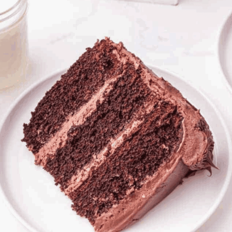 Slice of Cheesecake Factory Linda’s Fudge Cake with thick fudgy frosting and moist chocolate cake layers.