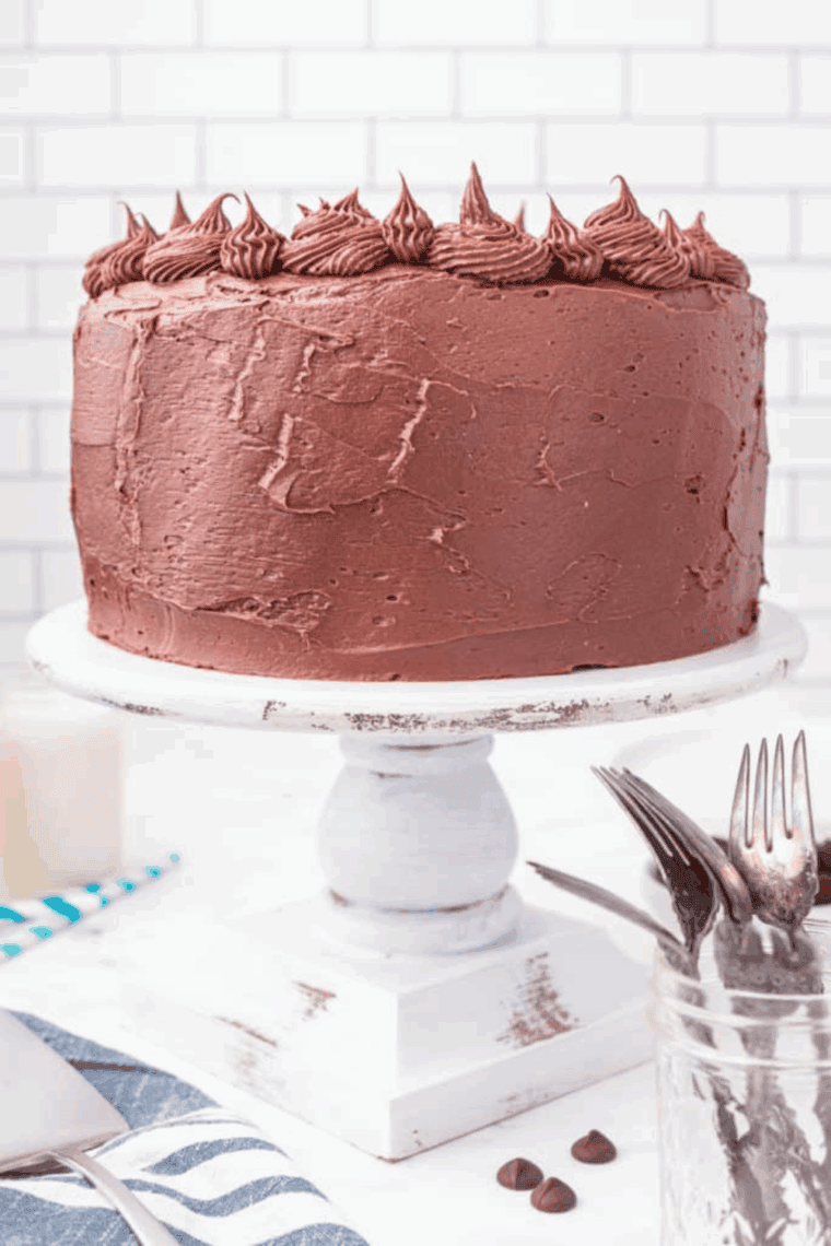 Slice of Cheesecake Factory Linda’s Fudge Cake with fudgy chocolate layers and creamy frosting.