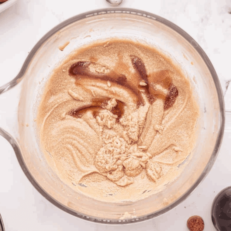 Combining rich chocolate cake batter using sifted dry and wet ingredients, prepared for pouring into greased baking pans.
