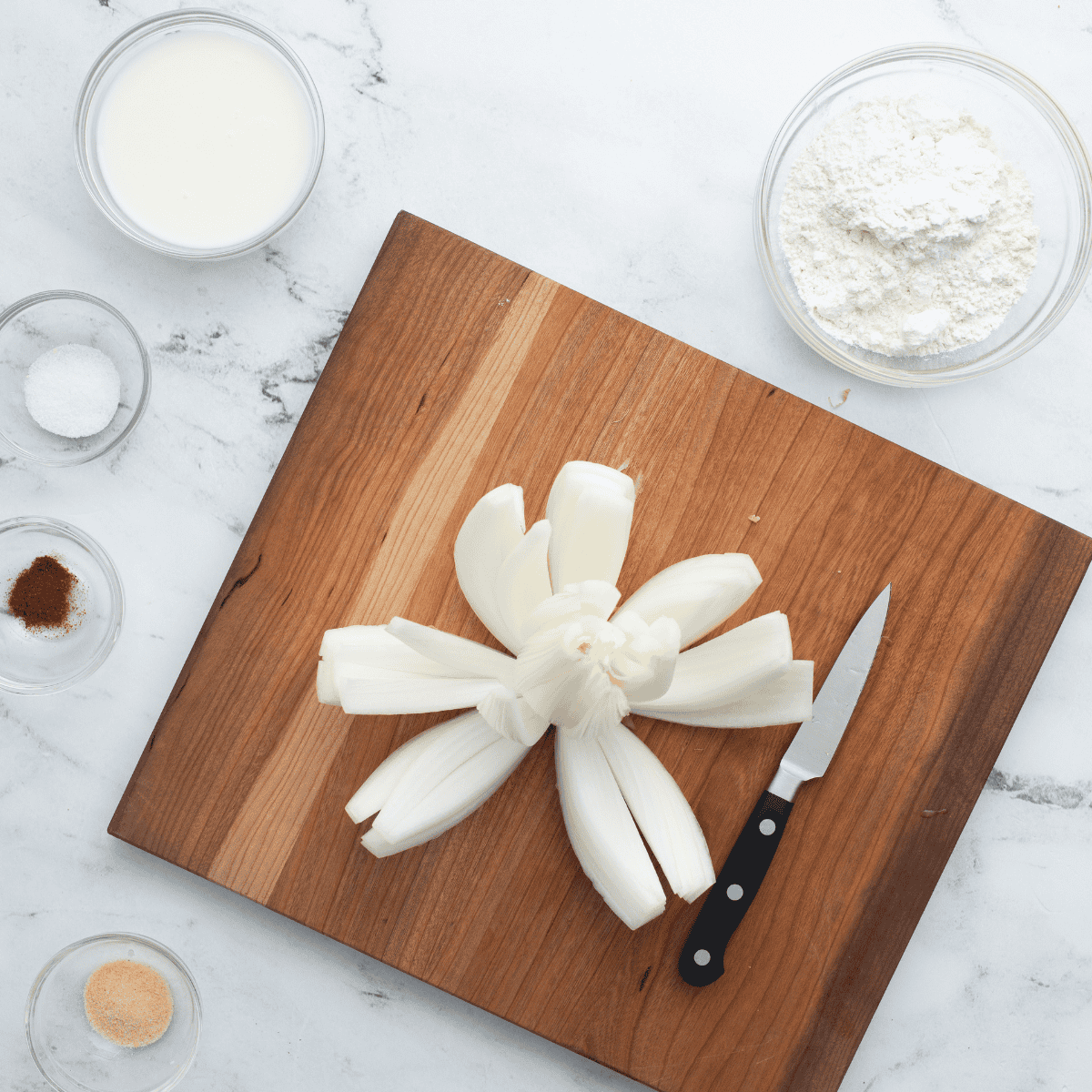 Using a sharp knife, cut the onion into sections.