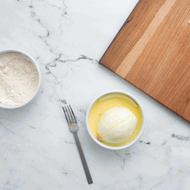 Whisking eggs and buttermilk together in a medium bowl to prepare coating for onion