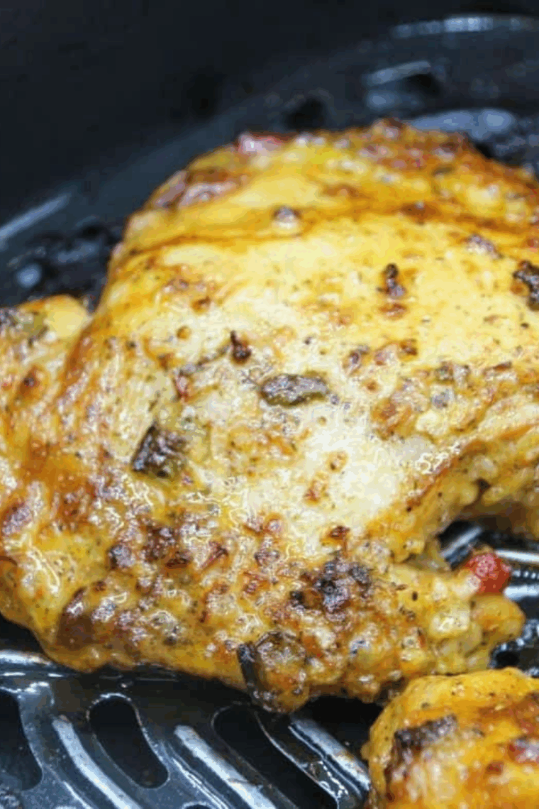 Air fryer Pollo Asado chicken cooked to golden perfection, served on a plate with fresh lime wedges and cilantro.