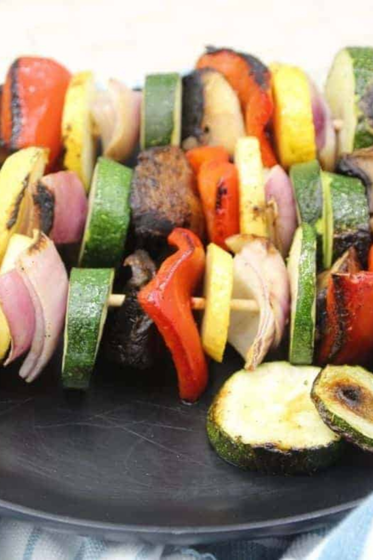 Colorful Blackstone griddle vegetable skewers with bell peppers, zucchini, mushrooms, and onions