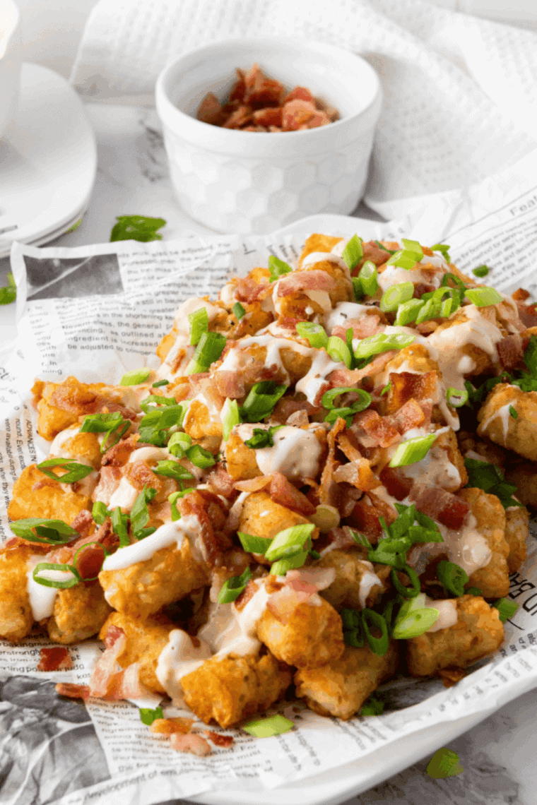 Golden Buffalo Wild Wings Tater Tots drizzled with ranch and coated in spicy buffalo sauce.
