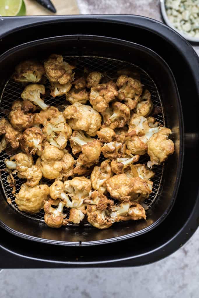 The Cauliflower Bites are on the grill in the air fryer and have finished cooking. They have turned a deep golden color.