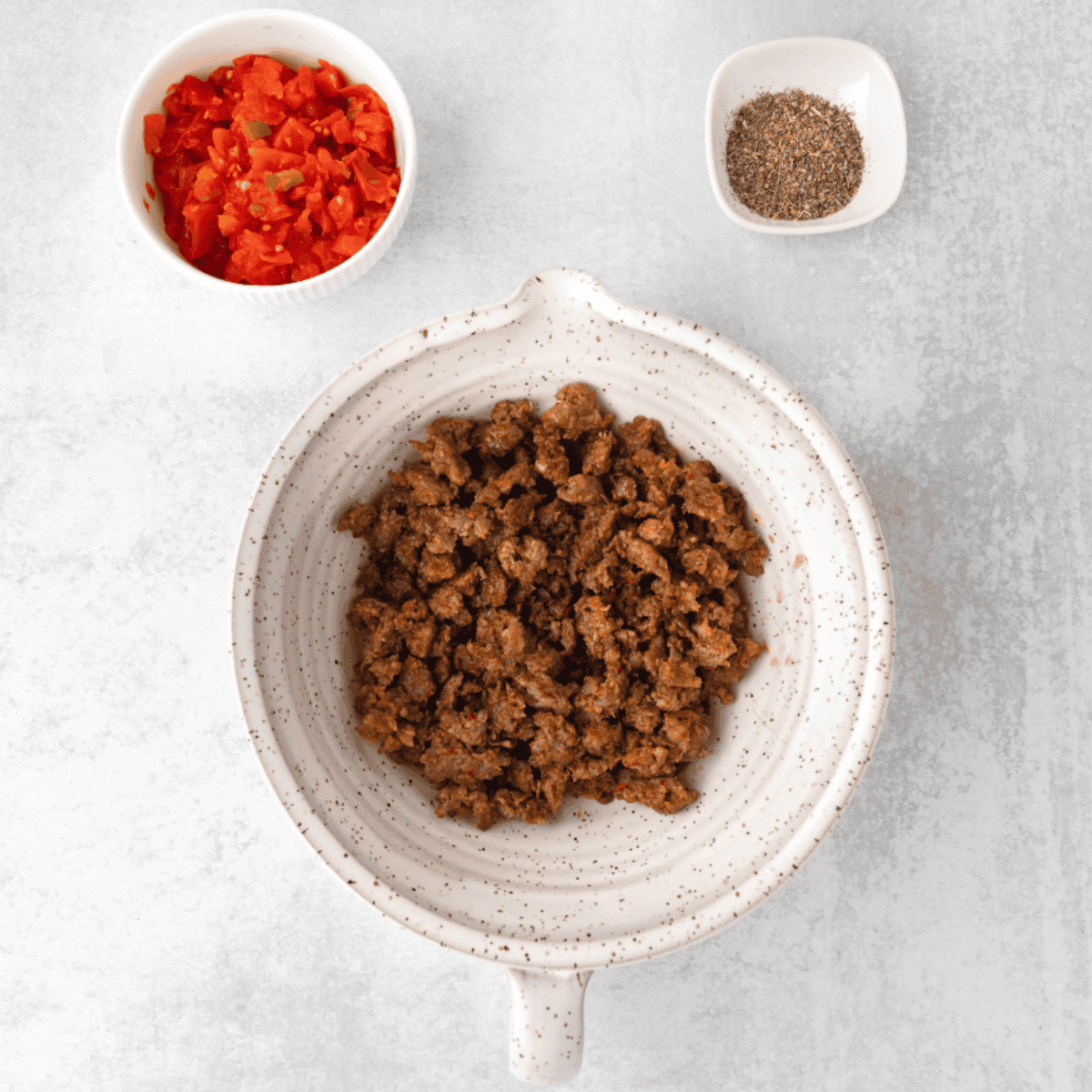 Cooked sausage, diced tomatoes and green chilies and spices for the breakfast casserole