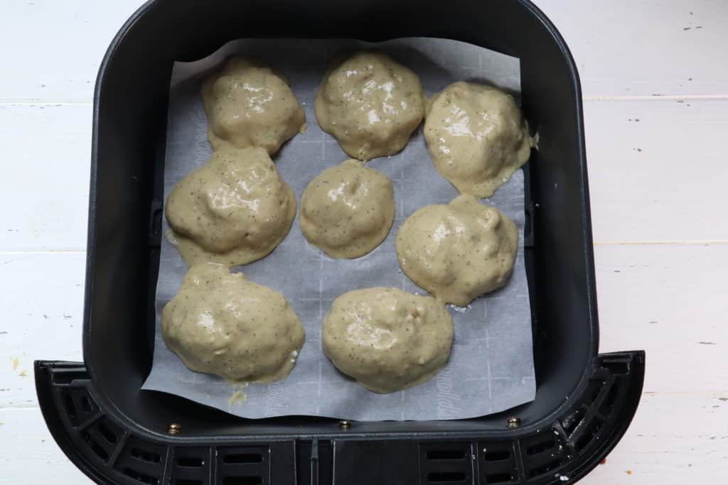 Air Fryer Chicken Nuggtes Add a piece of parchment to the air fryer, then add the frozen chicken nuggets, air fry at 370 degrees F, air fryer setting for 7 to 12 minutes. 