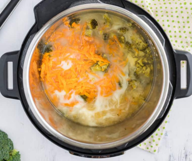 "Image of sautéing onions and garlic in a pot as the first step in making Broccoli Cheese Soup."