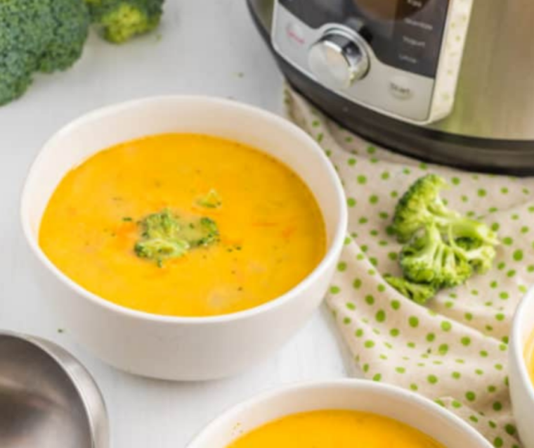 "Comforting bowl of Jason's Deli Broccoli Cheese Soup, with a golden cheese layer and a hint of fresh herbs on top."