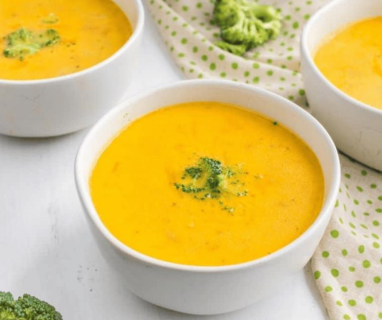 "Creamy Instant Pot Copycat Jason's Deli Broccoli Cheese Soup served in a bowl, with vibrant green broccoli pieces and melted cheese."