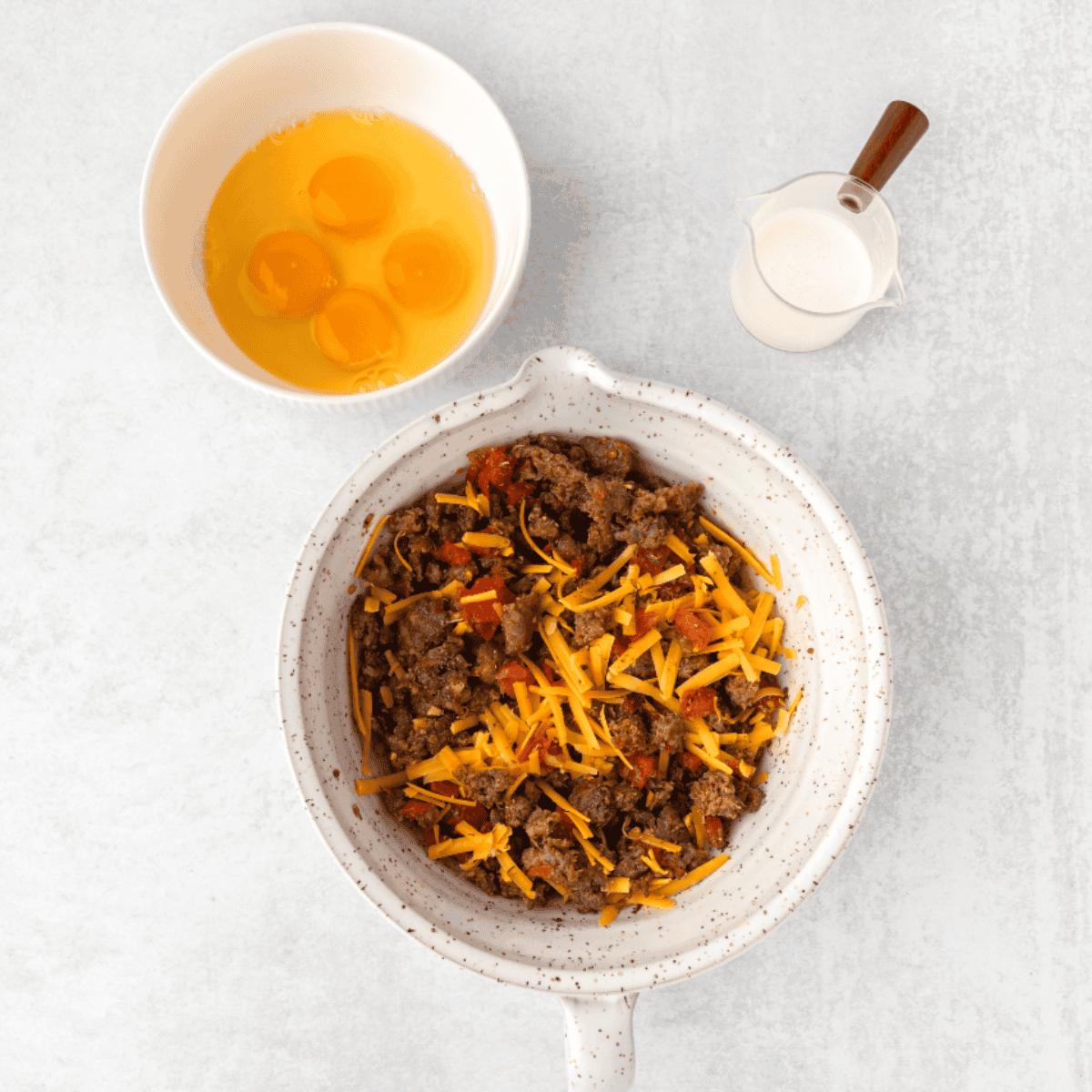 Preparing sausage, cheese, eggs and heavy cream for the  air fryer egg casserole