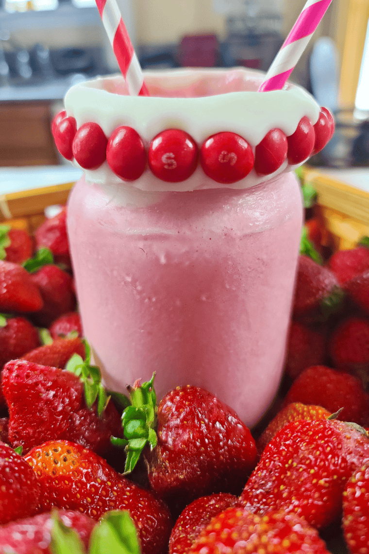 Close up of Skittles Strawberry Milkshake on kitchen table.