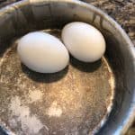 closeup: 2 eggs in a pan to make soft boiled egg in air fryer