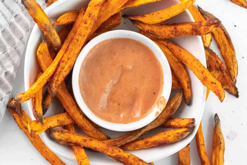 air fryer sweet potato fries in a bowl with dipping sauce