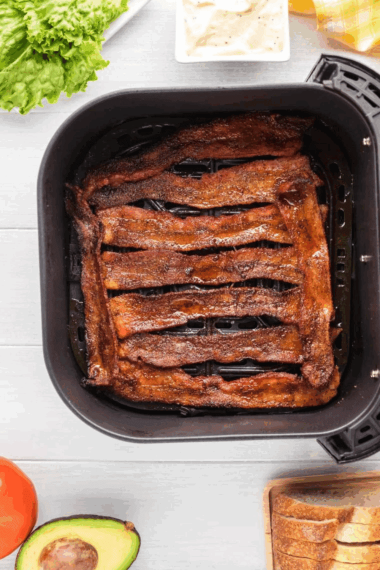 Cooked bacon jerky in the air fryer basket.