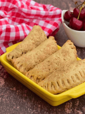 Air Fryer Cherry Hand Pies -- Are you looking for an easy and delicious dessert that will wow your guests? Look no further than these air fryer cherry hand pies. Not only are they beautiful to behold, but the combination of sweet-tart cherries encased in buttery puff pastry is divine. Furthermore, you can make them quickly and easily with just a few simple ingredients and an air fryer – there’s barely any mess! So, if you’re ready to bypass laborious baking time for a delectable treat, read on as we guide you through making these yummy delights!