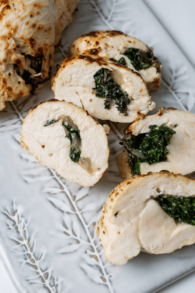 Crispy air fryer Chicken Kiev sliced open with melted garlic herb butter oozing from juicy chicken breast center.