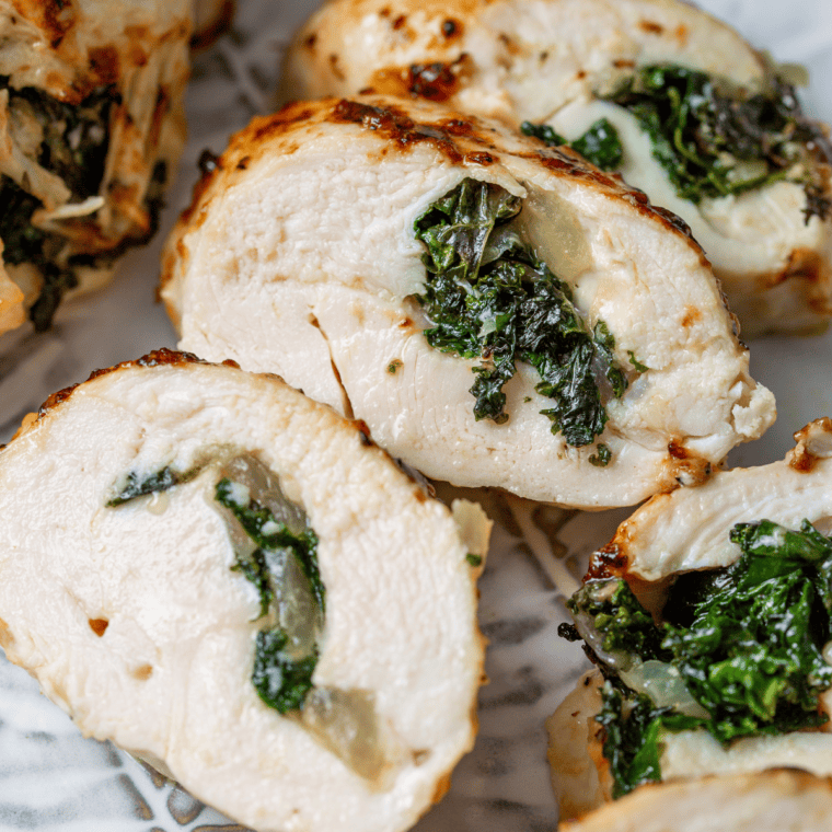 Crispy air fryer Chicken Kiev sliced open showing melted garlic herb butter oozing from the center of juicy chicken breast.