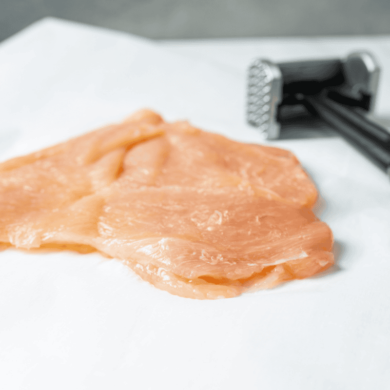 Chicken breast stuffed with herb butter, rolled tightly and secured with toothpicks, then chilled in freezer to firm before cooking.