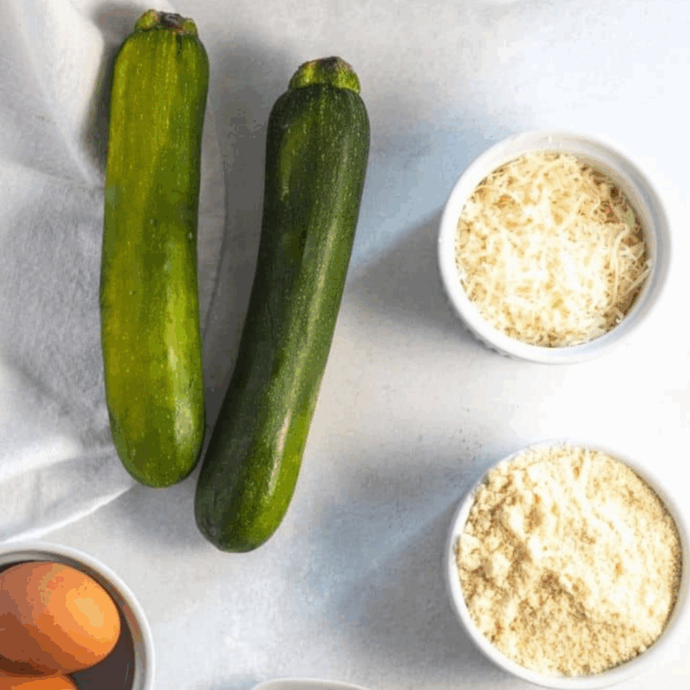 Ingredients needed for Air Fryer Everything Bagel Zucchini Chips on kitchen table.
