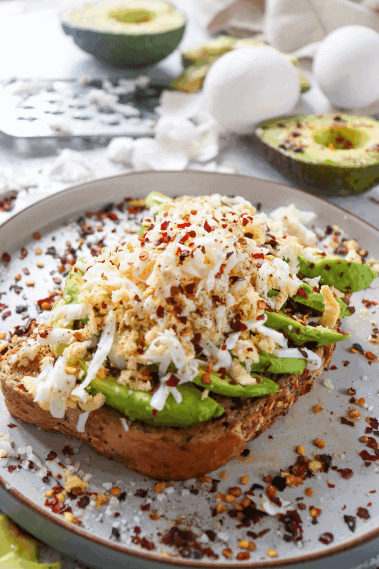 Air Fryer Grated Egg & Avocado Toast with creamy avocado, freshly grated egg, and seasoning on crispy, golden toast.