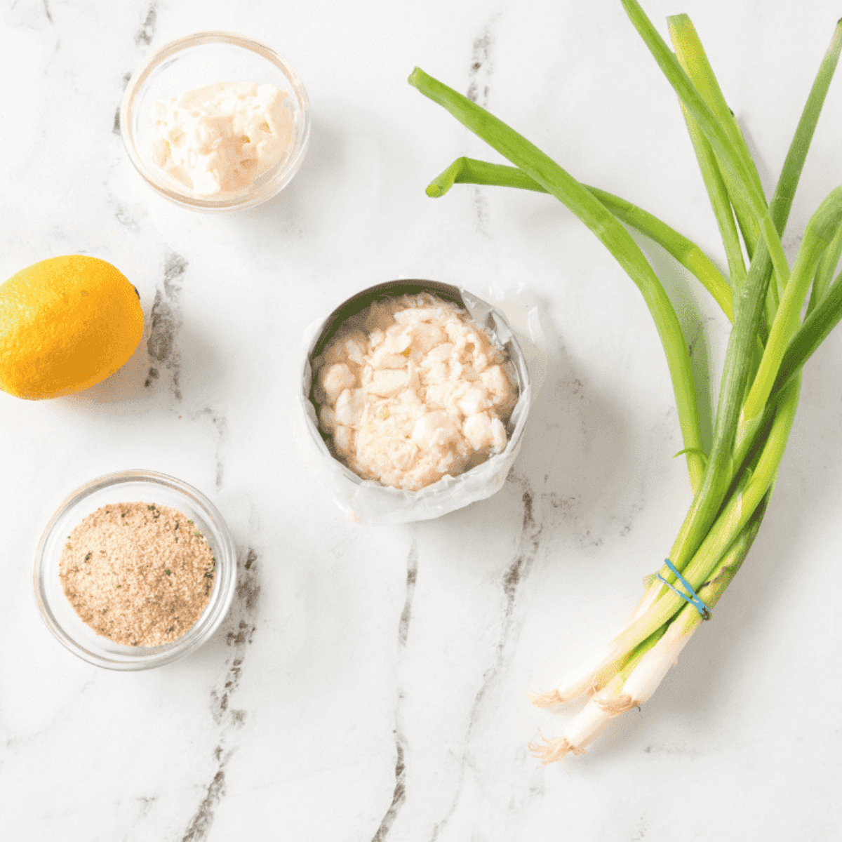 Ingredients needed for Air Fryer Lemon Crab Cakes on kitchen table.