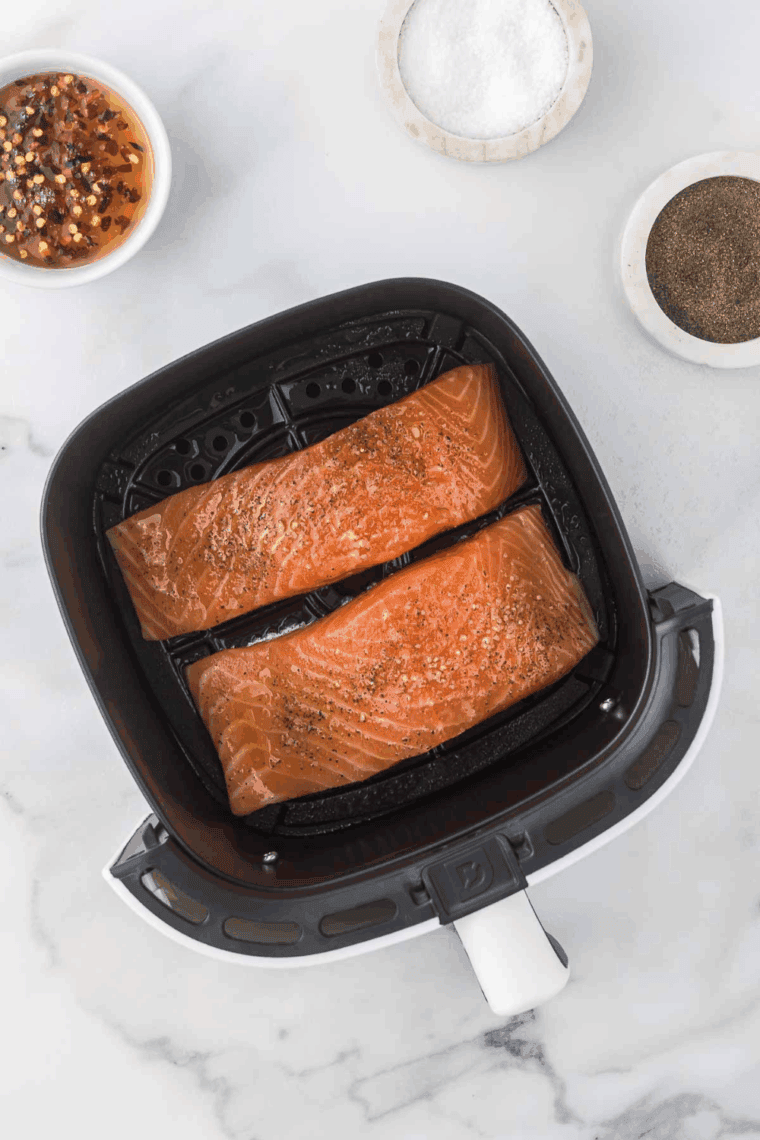 Cooked salmon drizzled with extra glaze and garnished with herbs