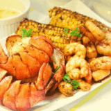Delicious Air Fryer Seafood Boil with shrimp, crab, and seasoning, served on a platter.
