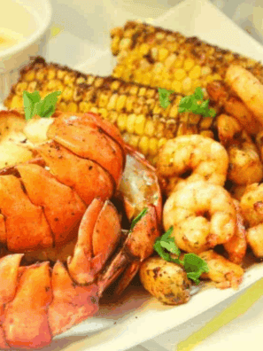 Delicious Air Fryer Seafood Boil with shrimp, crab, and seasoning, served on a platter.