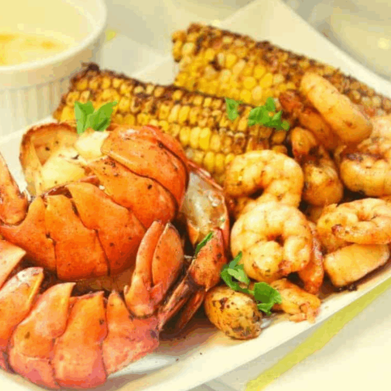 Delicious Air Fryer Seafood Boil with shrimp, crab, and seasoning, served on a platter.