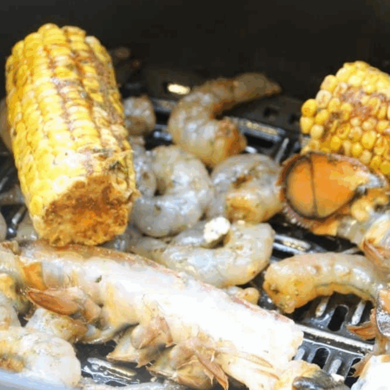 Place seafood boil ingredients into the air fryer basket.