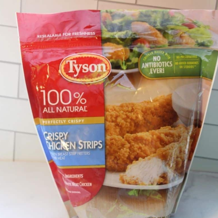 Bag of Crispy Tyson Frozen Chicken Strips on kitchen table.